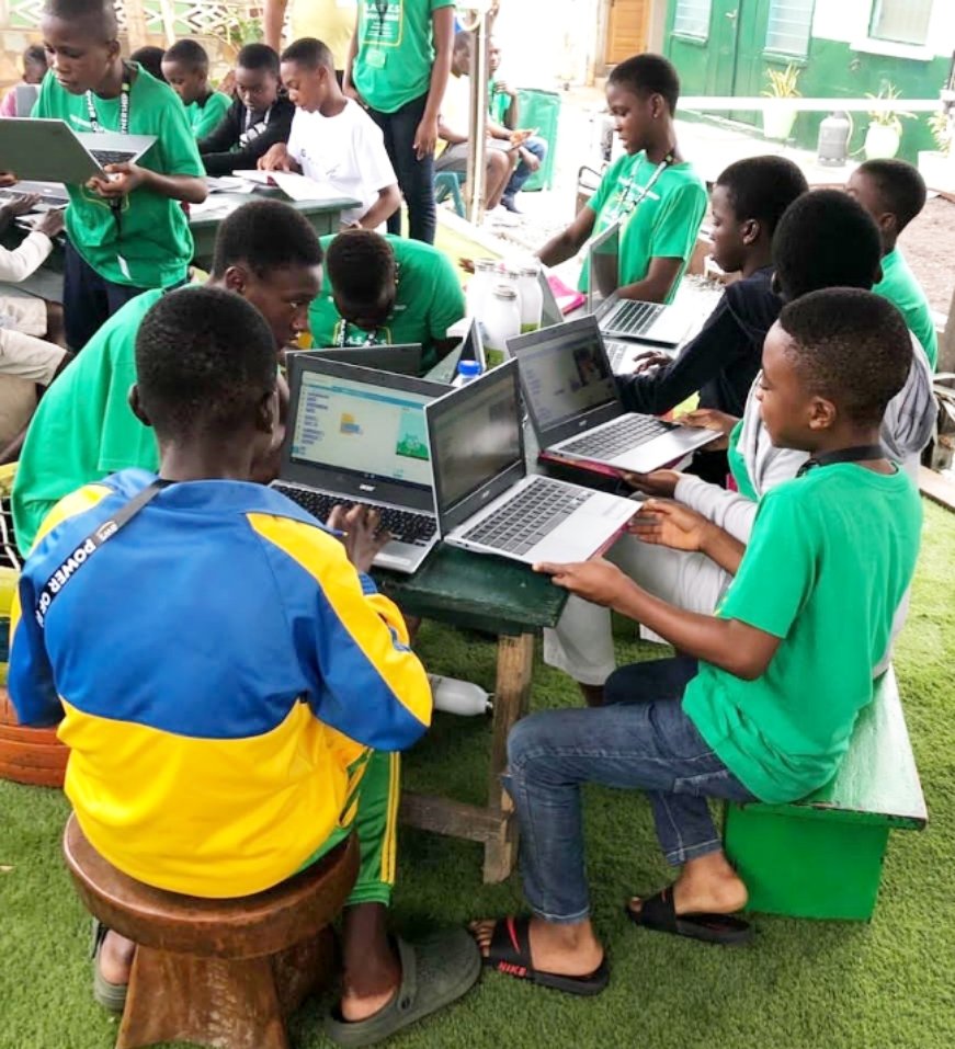 Children from BASIC International learning how to code