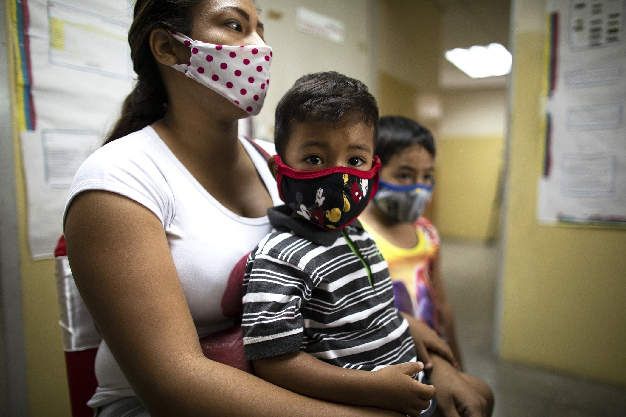 Two-year-old Matias Salazar waits with his mother before getting vaccinated during a mass vaccination day in Caracas, Venezuela on May 26, 2021.