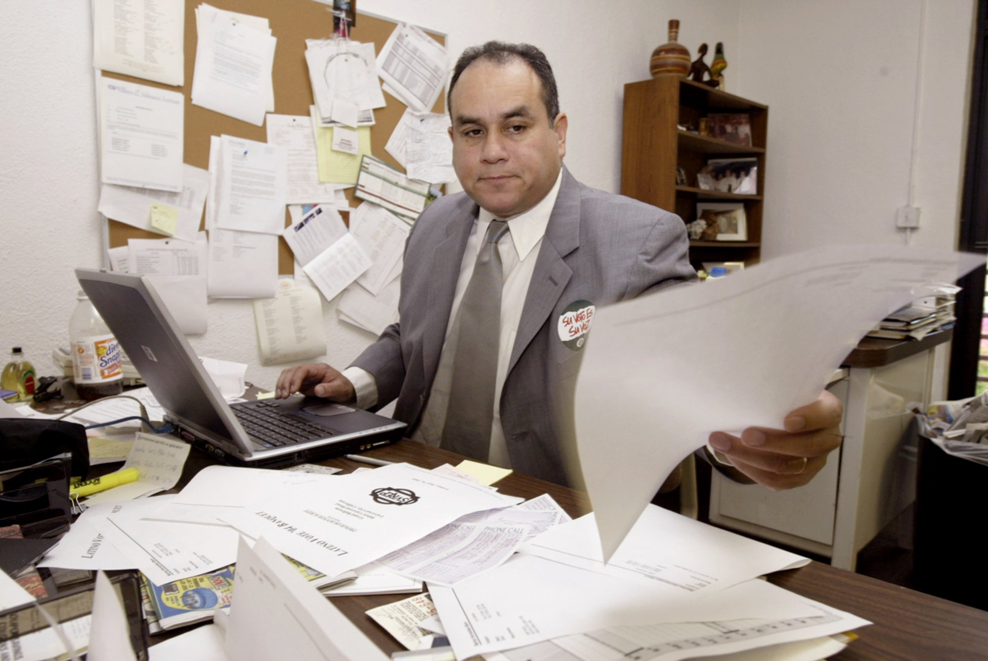 Antonio Gonzalez, president of the Southwest Voter Registration Education Project, works in his office in Los Angeles' Boyle Heights district, July 15, 2004.