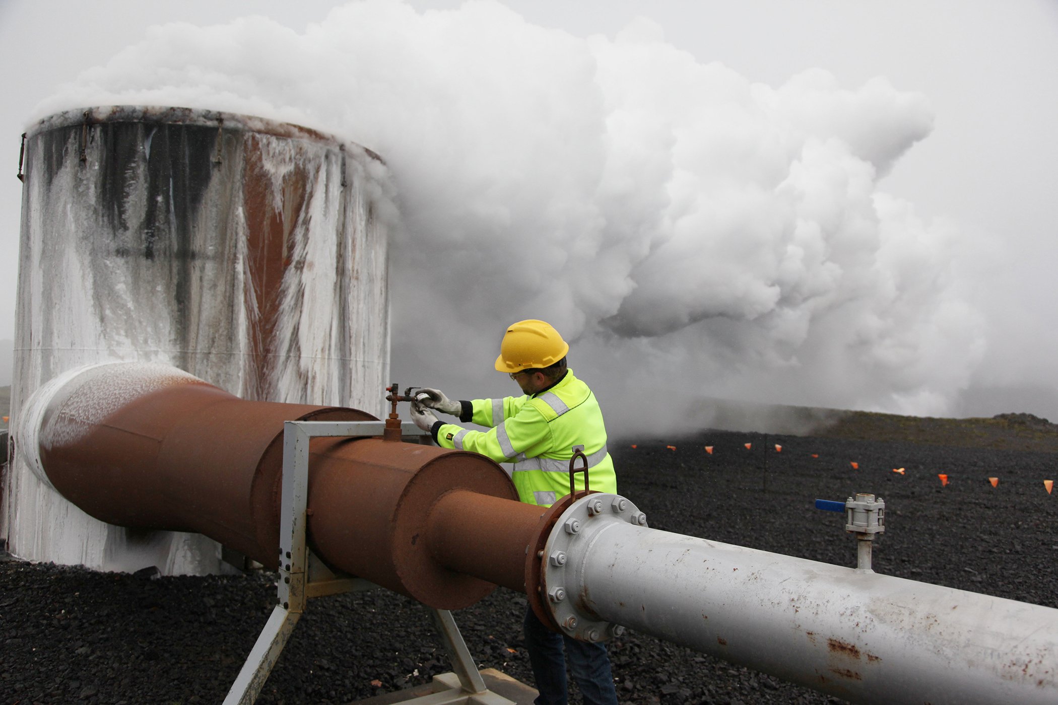 A CarbFix technical manager, checks a valve at a test well at Reykjavik Energy's Hellisheidi geothermal power plant in Iceland, July 2011. Scientists have a found a quick but not cheap way to turn heat-trapping carbon dioxide into harmless rock.