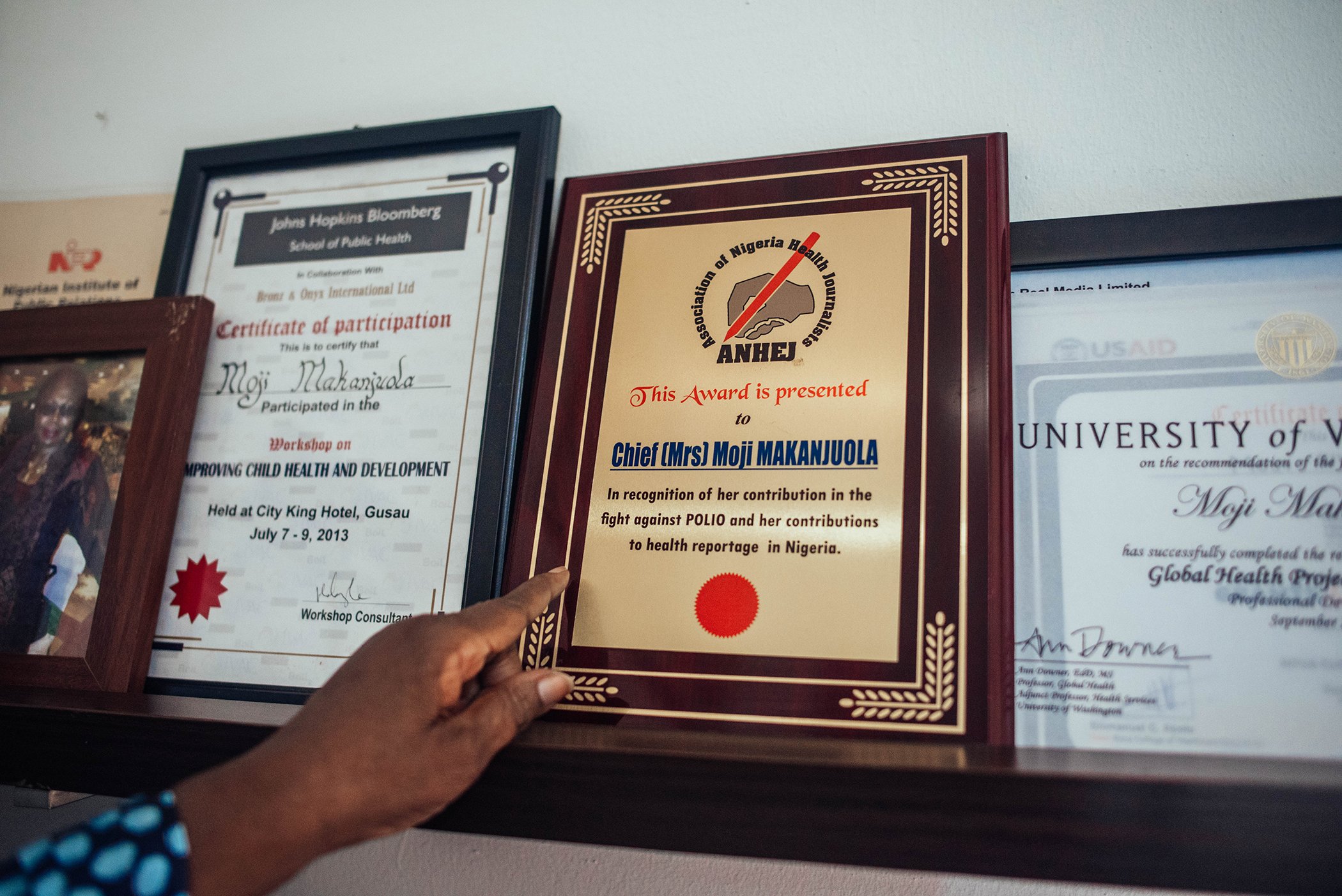 Moji Makanjuola shows off some of her career awards and certifications at her office in Garki, Abuja, Nigeria on Dec. 16, 2020.