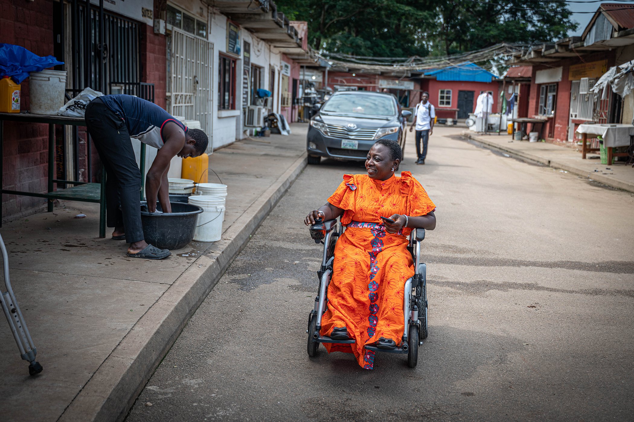 Lois Auta is photographed on the way to work in Abuja, Nigeria in August 2023. Auta was diagnosed with polio when she was a young child. The highly infectious disease invades the body's nervous system and can cause paralysis.